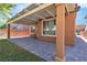 Covered patio with brick flooring and artificial grass at 11014 Great Sioux Rd, Las Vegas, NV 89179