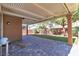 Covered brick patio and landscaped backyard offer an ideal outdoor living space at 11014 Great Sioux Rd, Las Vegas, NV 89179
