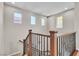 Upstairs stairwell featuring wood and decorative iron bannister and windows at 11014 Great Sioux Rd, Las Vegas, NV 89179