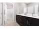 Elegant bathroom with double sinks, modern fixtures, and a glass-enclosed shower, offering a spa-like experience at 11256 Rainbow Peak Ave # 202, Las Vegas, NV 89135