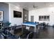 Bright game room featuring a pool table, tables with chairs, ceiling fan, and mounted television for entertainment at 11256 Rainbow Peak Ave # 202, Las Vegas, NV 89135