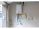 Garage featuring a modern, energy-efficient tankless water heater at 11256 Rainbow Peak Ave # 202, Las Vegas, NV 89135