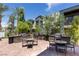 Outdoor grilling area with built-in grills, tables, and seating surrounded by lush greenery at 11256 Rainbow Peak Ave # 202, Las Vegas, NV 89135