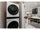 Convenient laundry room area located near the kitchen, featuring a stacked washer and dryer for space-saving efficiency at 11256 Rainbow Peak Ave # 202, Las Vegas, NV 89135