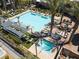 Beautiful outdoor pool and lounge area with palm trees at 11256 Rainbow Peak Ave # 202, Las Vegas, NV 89135
