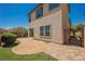 Two-story home featuring a quaint backyard area with artificial turf and pavers at 1180 Via Vinci, Henderson, NV 89052