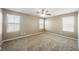 Spacious bedroom with plush carpeting, two large windows, and neutral paint throughout at 1180 Via Vinci, Henderson, NV 89052