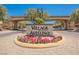 Village of Avellino entrance sign with flowerbed and arched entryway under a bright blue sky at 1180 Via Vinci, Henderson, NV 89052