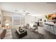 Open concept living area with natural light, ceiling fan, dining area, and breakfast bar with kitchen view at 1180 Via Vinci, Henderson, NV 89052