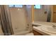 Bathroom featuring white tile shower and tub, tile countertops and updated faucet at 1211 Silver Knoll Ave, Las Vegas, NV 89123