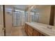 Bathroom with dual sinks, shower with glass doors, and tile flooring at 1211 Silver Knoll Ave, Las Vegas, NV 89123