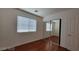Bedroom with wood floors, sliding mirror door closet, and bright window at 1211 Silver Knoll Ave, Las Vegas, NV 89123