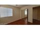 Bedroom features hardwood floors, a bright window, and mirrored closet doors at 1211 Silver Knoll Ave, Las Vegas, NV 89123