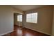 Bedroom features laminate wood floors, a bright window, and mirrored closet doors at 1211 Silver Knoll Ave, Las Vegas, NV 89123