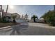 Wide view of the exterior showcasing the landscaping and multi-car garage at 1211 Silver Knoll Ave, Las Vegas, NV 89123