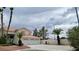 Two-story home featuring a three-car garage, desert landscaping and a red tile roof at 1211 Silver Knoll Ave, Las Vegas, NV 89123