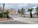 Two-story home featuring a three-car garage, desert landscaping and a red tile roof at 1211 Silver Knoll Ave, Las Vegas, NV 89123