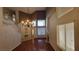 Bright living room with hardwood floors, fireplace, chandelier, staircase, and large windows at 1211 Silver Knoll Ave, Las Vegas, NV 89123