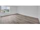 Bright bedroom with wood-look flooring and a large window offering natural light at 1424 Santa Anita Dr # D, Las Vegas, NV 89119