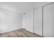 This bedroom features wood-look flooring, white walls, and a closet for storage at 1424 Santa Anita Dr # D, Las Vegas, NV 89119