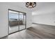 Bright living room with modern wood-look flooring and access to an outdoor patio at 1424 Santa Anita Dr # D, Las Vegas, NV 89119