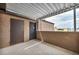 Outdoor patio with metal awning, door, and storage, offering privacy and shade at 1424 Santa Anita Dr # D, Las Vegas, NV 89119