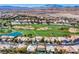 Panoramic aerial view of a golf course community with lush greens, winding paths, and stunning desert landscape at 151 Cliff Valley Dr, Las Vegas, NV 89148