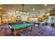 Billiard room with multiple pool tables, carpet, and lighting, perfect for entertainment and relaxation at 151 Cliff Valley Dr, Las Vegas, NV 89148