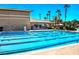 Community lap pool featuring swimming lanes with views of the clubhouse and resort style common area at 151 Cliff Valley Dr, Las Vegas, NV 89148