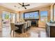 Bright dining room featuring travertine floors, modern lighting, fireplace, and an outdoor view at 151 Cliff Valley Dr, Las Vegas, NV 89148