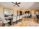 Spacious dining room with travertine floors, modern lighting and adjacent kitchen at 151 Cliff Valley Dr, Las Vegas, NV 89148