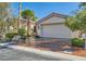 Inviting single-story home boasts a two-car garage and beautifully landscaped front yard at 151 Cliff Valley Dr, Las Vegas, NV 89148