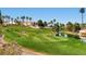 Beautiful golf course landscape with vibrant green fairways, a serene pond, and picturesque palm trees at 151 Cliff Valley Dr, Las Vegas, NV 89148