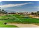 Expansive golf course featuring sprinklers, lush green fairways, mature trees, and distant mountain views at 151 Cliff Valley Dr, Las Vegas, NV 89148