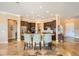 Kitchen island featuring counter seating, stainless appliances, travertine floors, and custom cabinets at 151 Cliff Valley Dr, Las Vegas, NV 89148