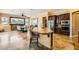 Open concept kitchen and dining with travertine floors, island, and dining table at 151 Cliff Valley Dr, Las Vegas, NV 89148
