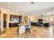 Open living space with kitchen island, travertine floors, and comfortable living room at 151 Cliff Valley Dr, Las Vegas, NV 89148