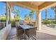 Covered outdoor patio area featuring built-in barbecue, dining table, and view of the lush backyard at 151 Cliff Valley Dr, Las Vegas, NV 89148