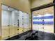 Indoor racquetball court with glass doors and a bench, offering a space for fitness and recreation at 151 Cliff Valley Dr, Las Vegas, NV 89148