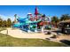 Vibrant community water park with towering slides, splash features, and green landscaping under a clear blue sky at 151 Cliff Valley Dr, Las Vegas, NV 89148