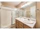 Bright bathroom featuring a dual sink vanity and glass enclosed walk-in shower at 1557 Lake Placid Ter # 1557, Henderson, NV 89014