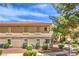 Side view of an apartment home with well-maintained landscaping and mature trees providing ample shade at 1557 Lake Placid Ter # 1557, Henderson, NV 89014