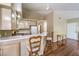 A view of the kitchen area showing bar seating and white appliances at 1557 Lake Placid Ter # 1557, Henderson, NV 89014
