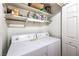 Laundry room with a washer and dryer and storage shelving at 1557 Lake Placid Ter # 1557, Henderson, NV 89014