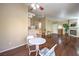 Spacious living area featuring a table set, hardwood floors, natural light, and a fireplace at 1557 Lake Placid Ter # 1557, Henderson, NV 89014