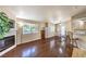 Open-concept living area featuring hardwood floors, a fireplace, a window with natural light, and neutral paint at 1557 Lake Placid Ter # 1557, Henderson, NV 89014
