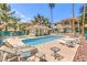 Inviting community pool area with chairs, lounge seating and mature trees at 1557 Lake Placid Ter # 1557, Henderson, NV 89014
