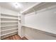 Bright walk-in closet featuring built-in shelving and hanging rods at 1557 Lake Placid Ter # 1557, Henderson, NV 89014