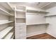 Walk-in closet with built in shelving, drawers and hanging rods at 1557 Lake Placid Ter # 1557, Henderson, NV 89014