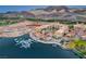 Stunning aerial view of lakefront properties with private docks and boats, set against a mountain backdrop at 1600 Pleasant Bay Ct, Henderson, NV 89011